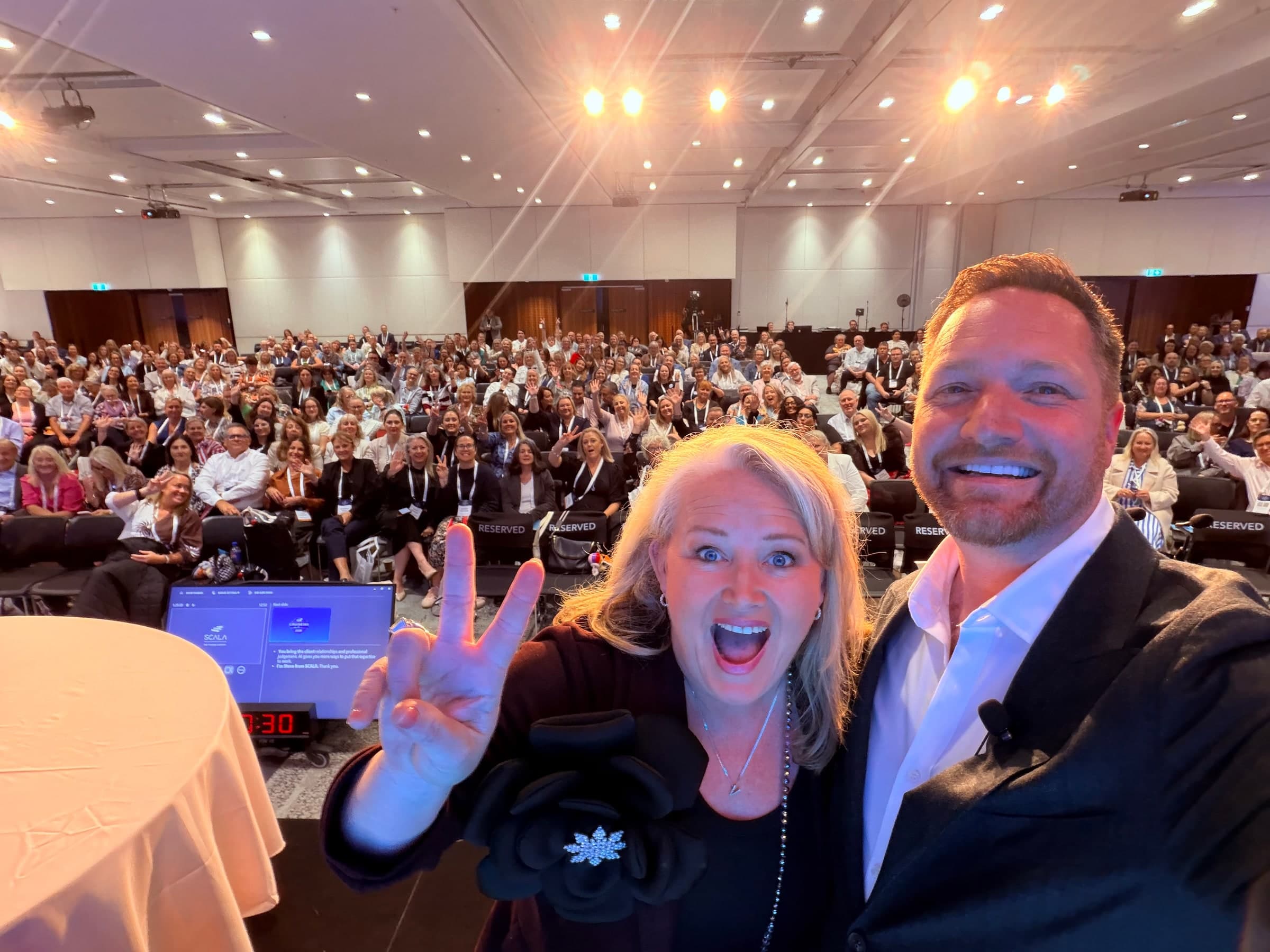 Steve and another participant in front of the Cruise360 conference audience